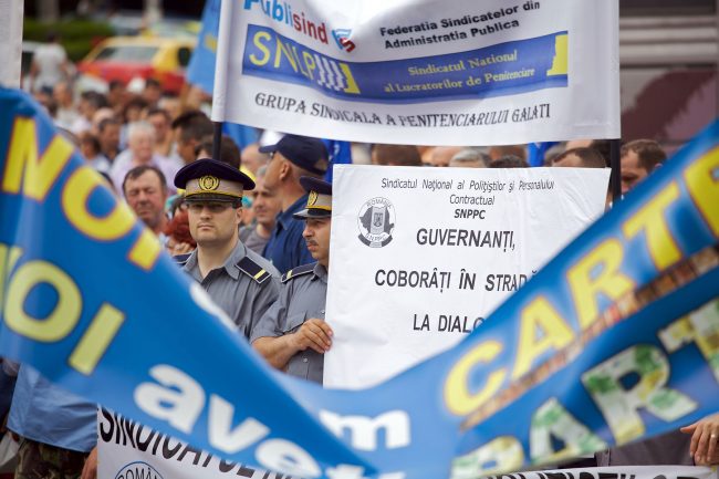 Policemens and other people are participating in a protest agains government austerity measures in Galați, Romania on June 1st, 2010.