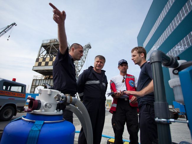 Members of Belgian First Aid Support Team (B-FAST) are liasing with Romanian counterparts at naval shipyard in Galați, Romania on July 8th, 2010.