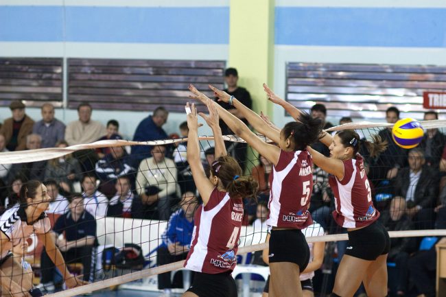 Voleyball players are fighting over the ball in a game played in Galați, Romania on April 25th, 2010.