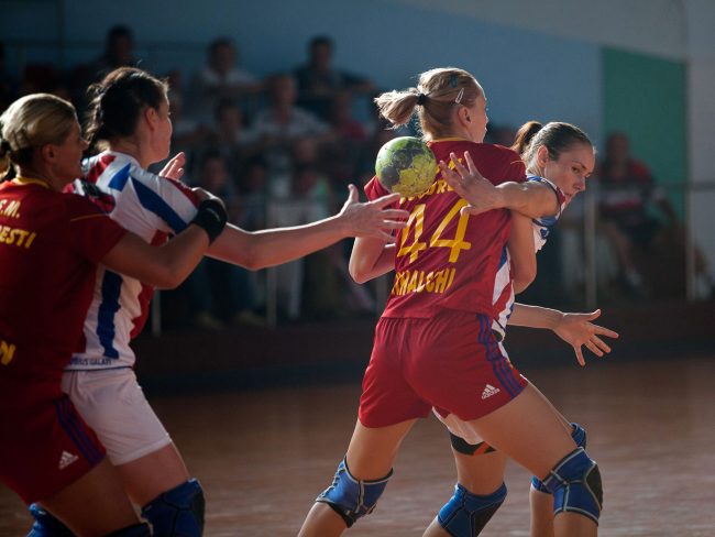 Handball players are fighting for the ball in a game played in Galati, Romania on September 6th, 2012.