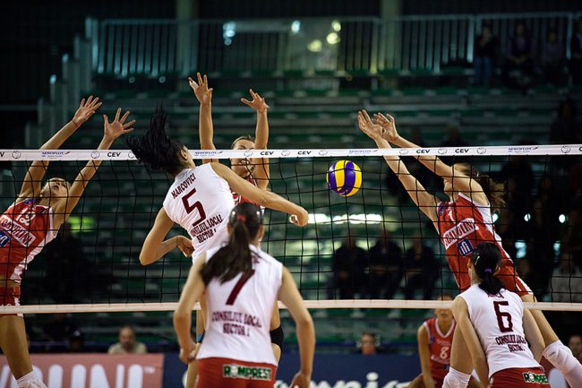 Volley players are playing in a CEV Cup match between Scavolini Pesaro (IT) and Dinamo București (RO) in Pesaro, Italy on December 8th, 2010.