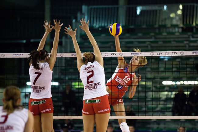 Volley players are playing in a CEV Cup match between Scavolini Pesaro (IT) and Dinamo București (RO) in Pesaro, Italy on December 8th, 2010.