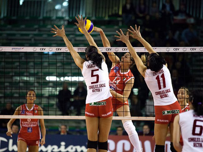 Volley players are playing in a CEV Cup match between Scavolini Pesaro (IT) and Dinamo București (RO) in Pesaro, Italy on December 8th, 2010.