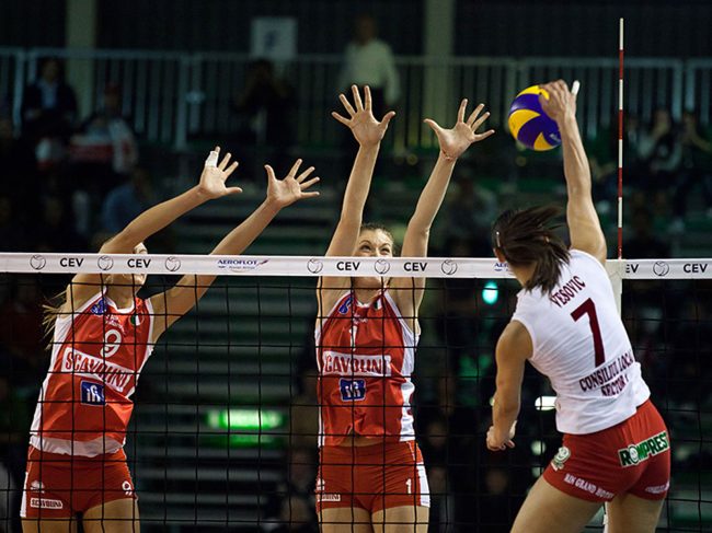 Volley players are playing in a CEV Cup match between Scavolini Pesaro (IT) and Dinamo București (RO) in Pesaro, Italy on December 8th, 2010.