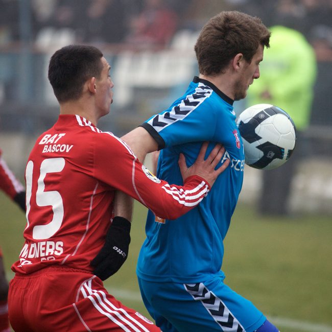 Football players are fighting for the ball in a game played in Galați, Romania on February 19th, 2010.