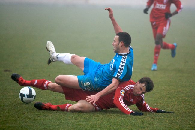 Football players are fighting for the ball in a game played in Galați, Romania on February 19th, 2010.