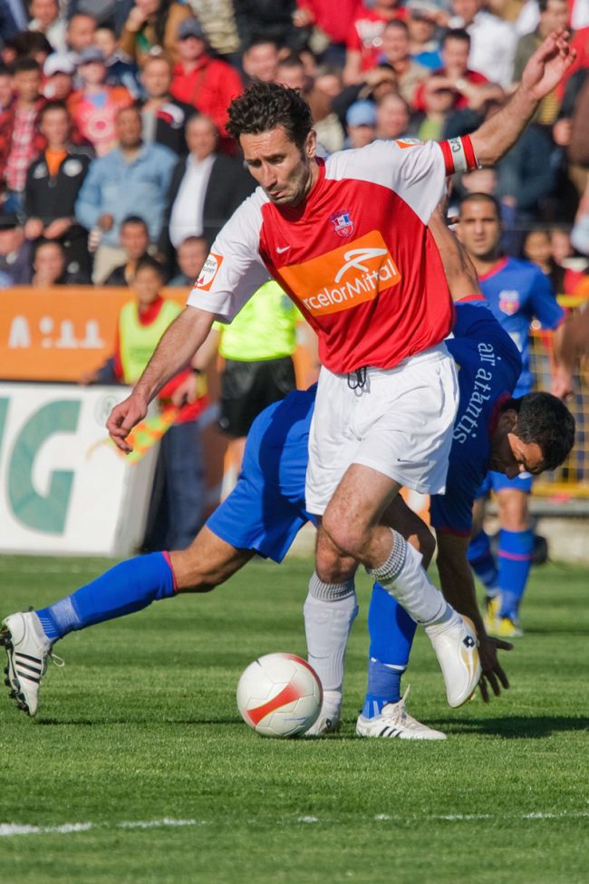 Football players are fighting for the ball in a game played in Galați, Romania on April 19th, 2008.